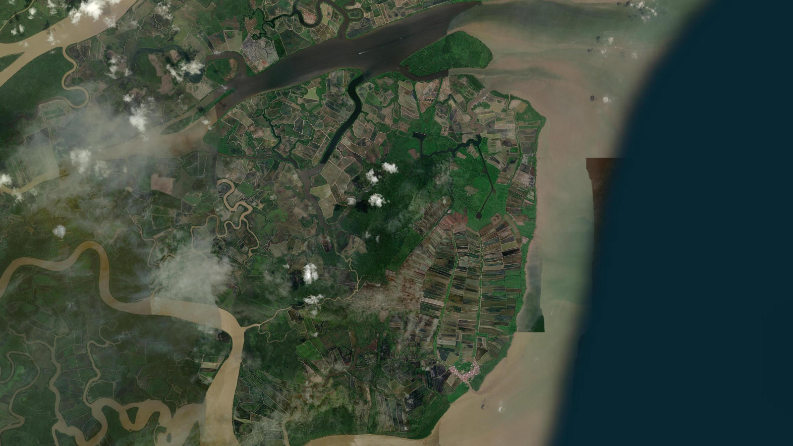 Satellite view of open-cut coal workings and haul roads in the East Kutai coal district of East Kalimantan, Indonesia, the kind of block a WIUP licence covers.