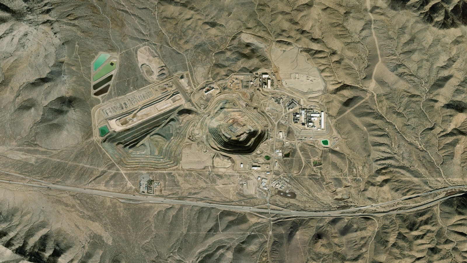 Satellite view of the Mountain Pass rare earth mine and open pit in the Mojave Desert of eastern California, the only operating rare earth mine in the United States.
