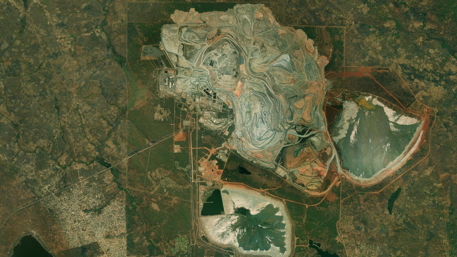 Satellite view of the Kansanshi open-pit copper-gold mine near Solwezi in North-Western Province, Zambia, showing the main pit, processing plant and tailings storage facilities.